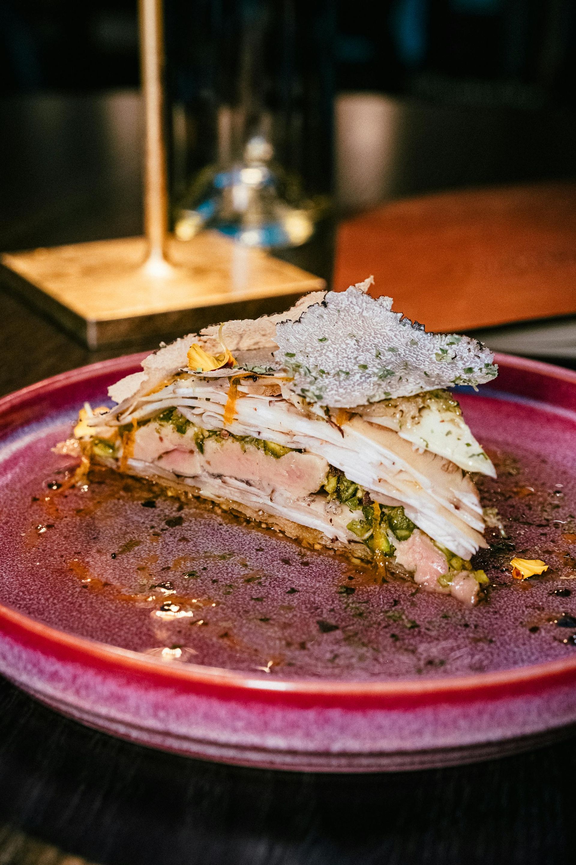 Round table set for dining, with chairs and place settings, in a restaurant.