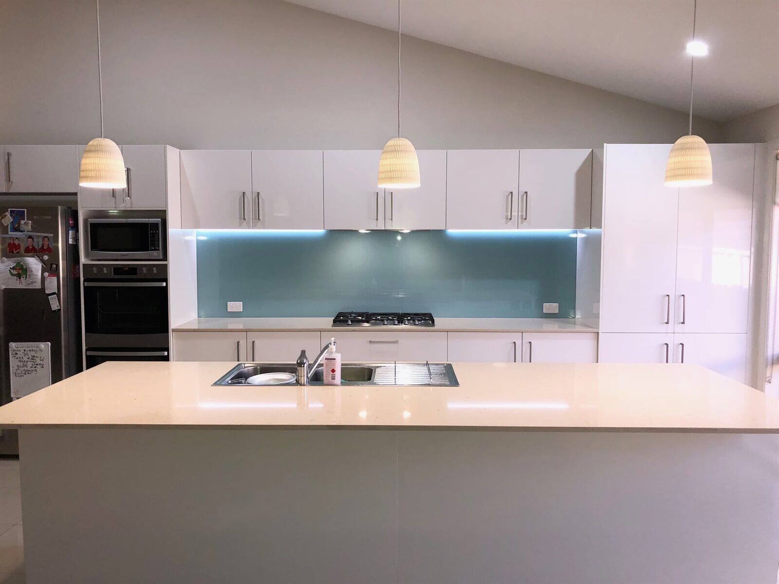 blue coloured glass splashback in a modern kitchen - Cessnock, NSW