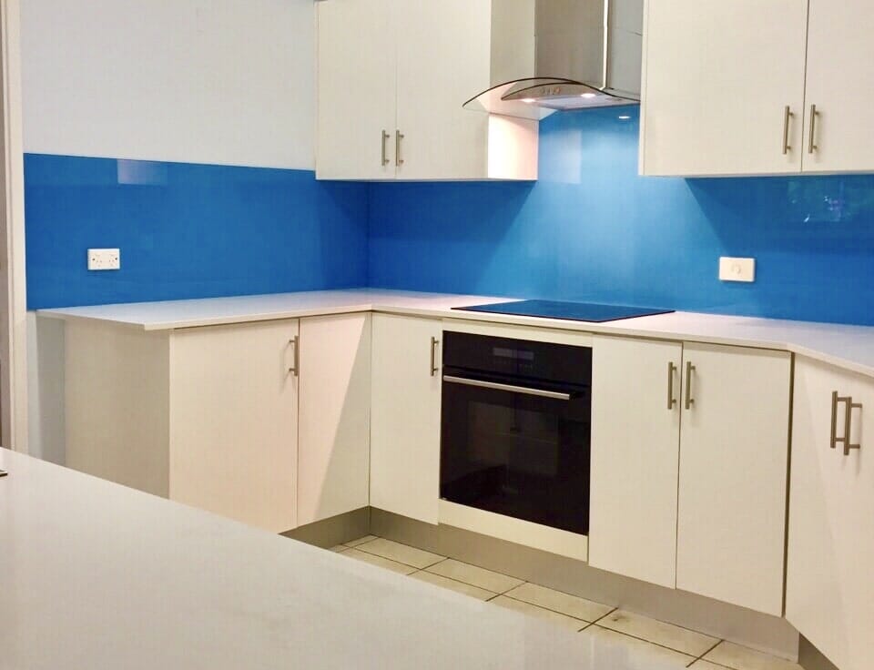 bright blue glass kitchen splashback with laminate kitchen cabinetry in  Cessnock, NSW