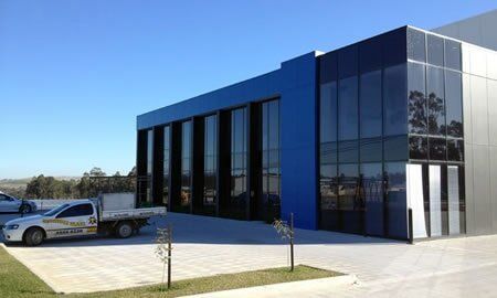 Glass windows in a building — Installing, repairing and manufacturing glass in Cessnock, NSW