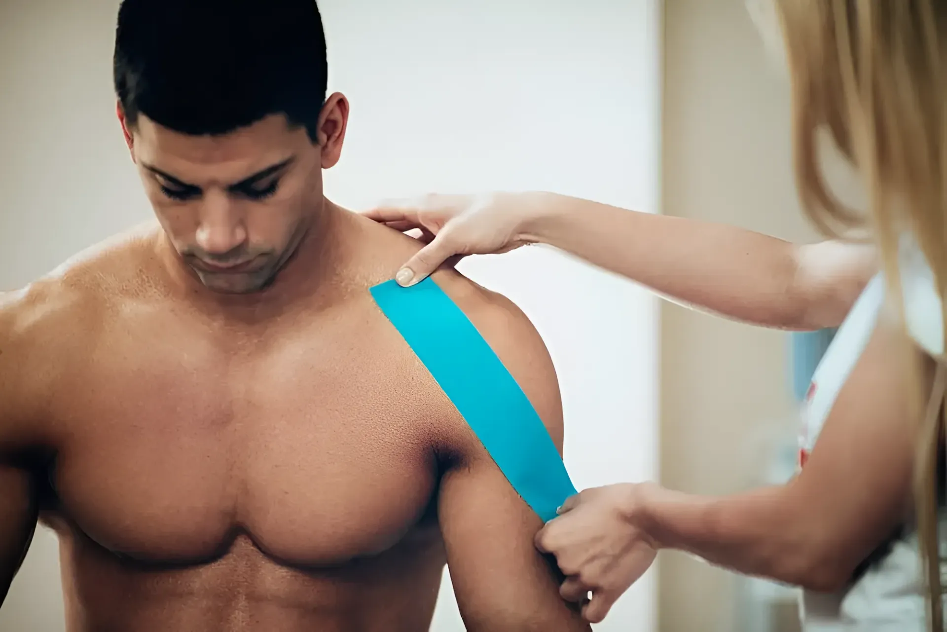 Person Having Athletic Tape Applied to Shoulder — Barolin Physiotherapy Services in Bundaberg South, QLD