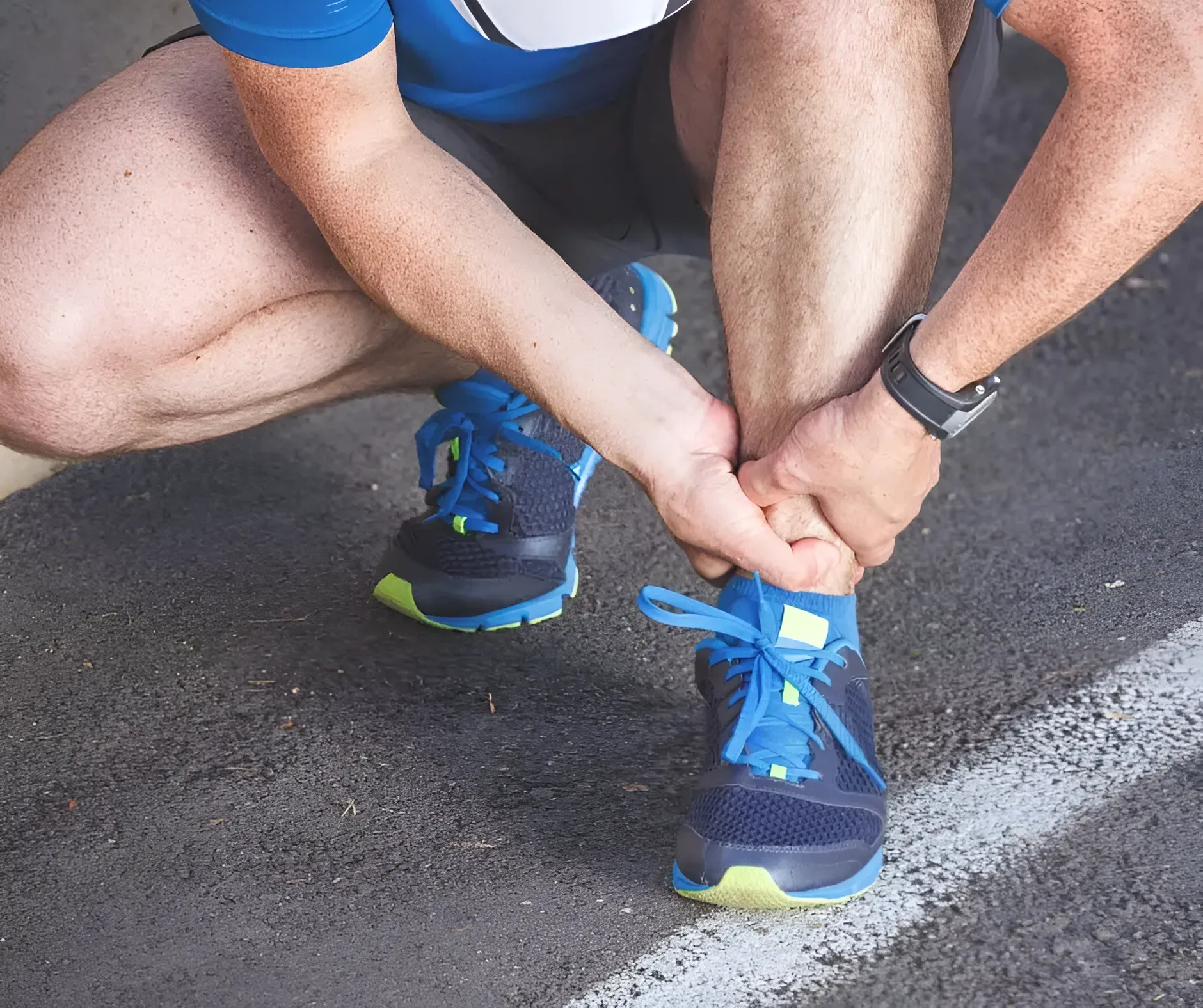 Runner Holding Ankle, Grimacing — Barolin Physiotherapy Services in Bundaberg South, QLD