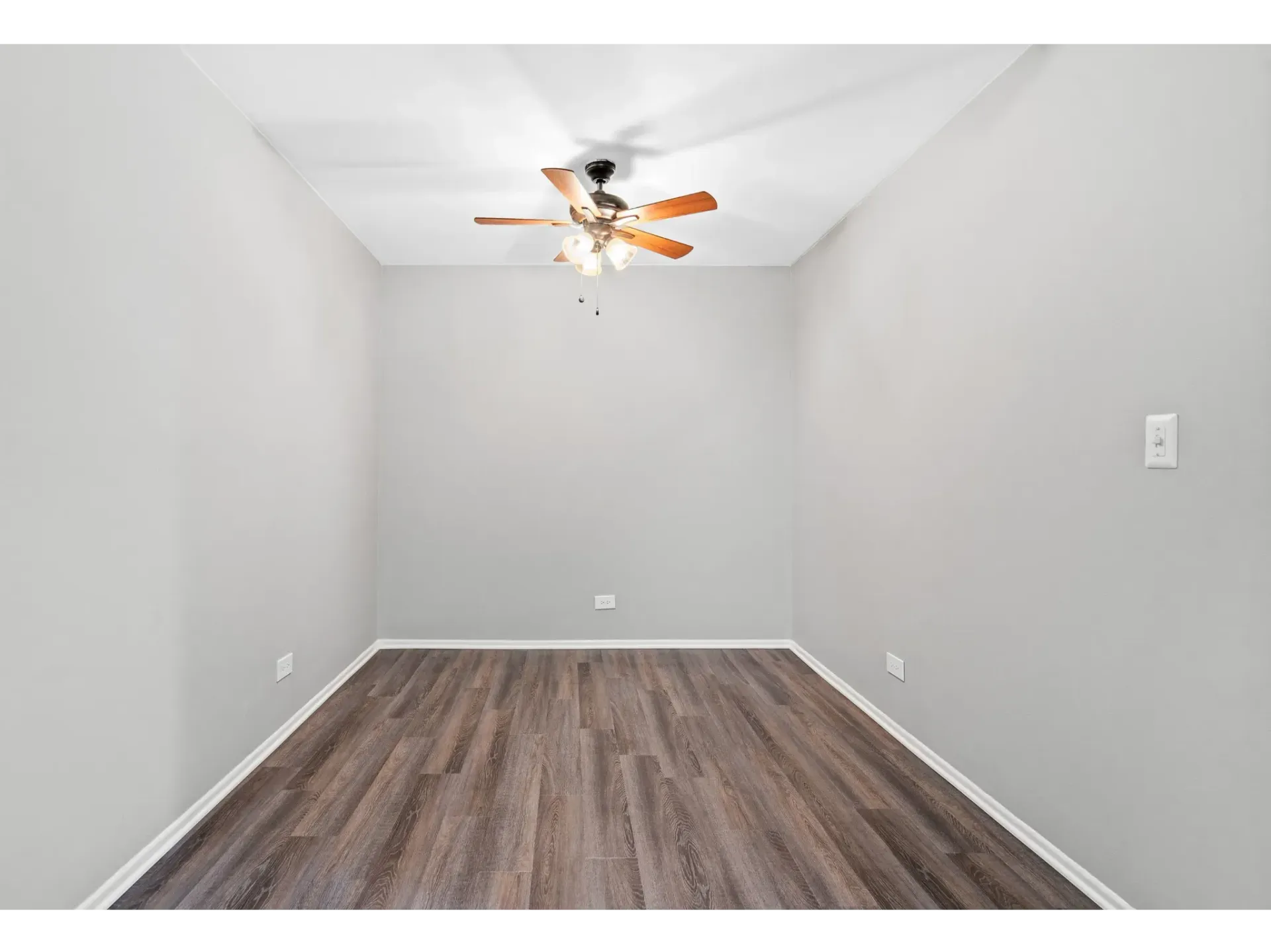 Empty apartment room with ceiling fan at Bartlett Lakes, offer pet-friendly apartments in Bartlett, IL.