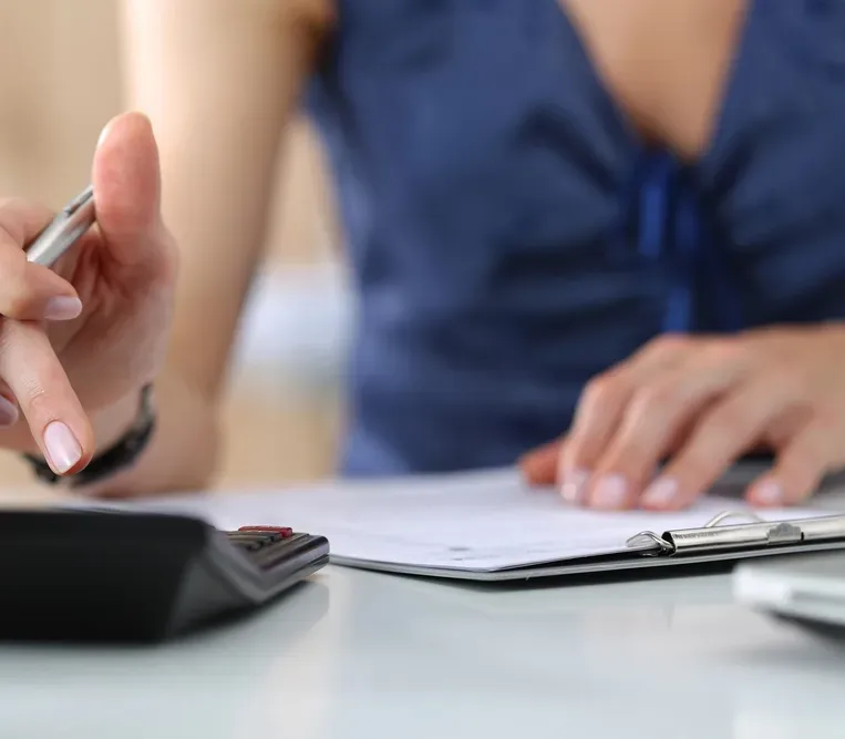 A Person Adding On A Calculator   — Money Spider Conveyancing In Katherine, NT