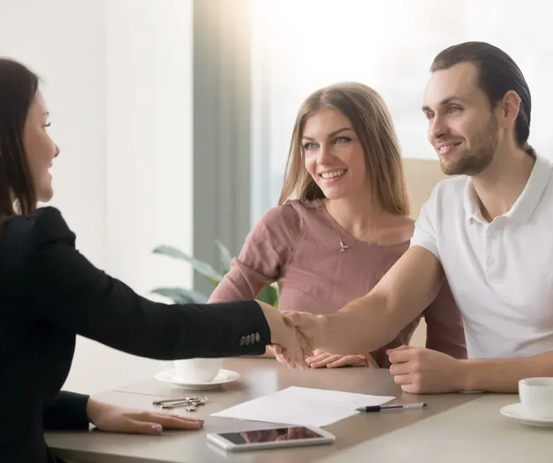 A Young Couple Signing a Contract With a Conveyancer — Money Spider Conveyancing In Katherine, NT