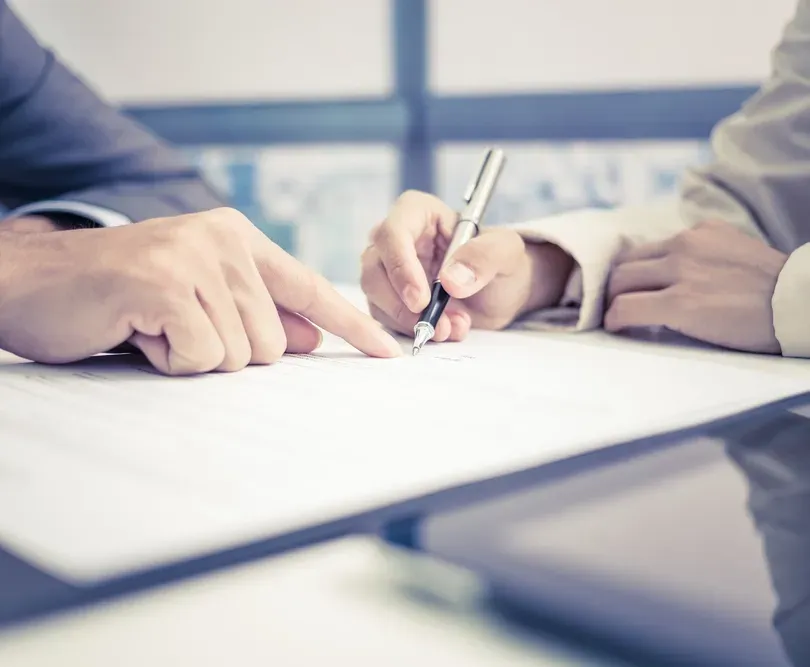 A Person Signing a Contract With A Pen— Money Spider Conveyancing In Katherine, NT