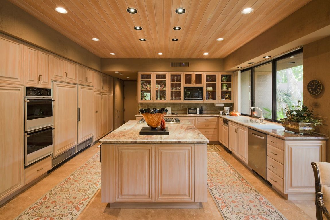 A kitchen with stainless steel appliances and wooden cabinets