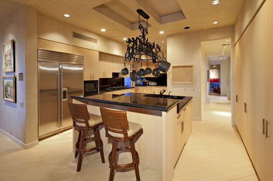 A kitchen with a large island and stools