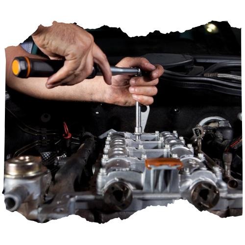 A man is working on a car engine with a screwdriver