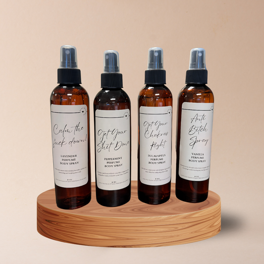 Four bottles of spray sitting on top of a wooden tray