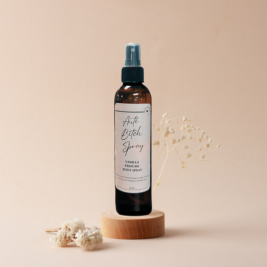 A bottle of spray sitting on top of a wooden block on a table.