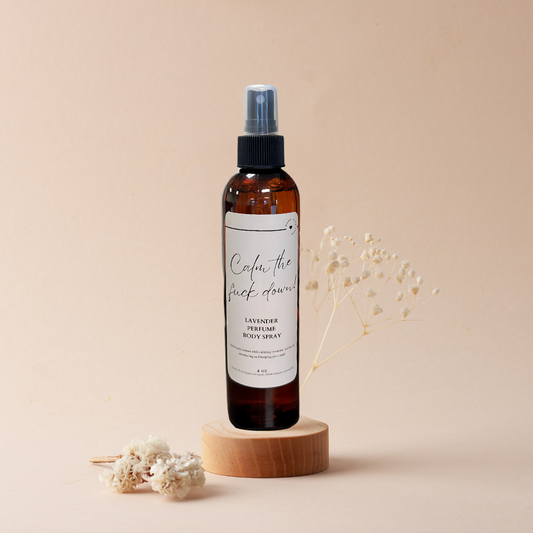 A bottle of spray sitting on top of a wooden block.