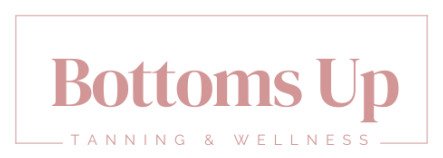 The logo for bottoms up tanning and wellness is pink and white.