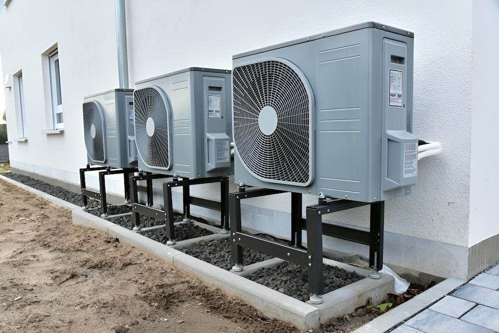 A Row Of Air Conditioners Are Sitting On The Side Of A Building — Mason's Air Conditioning Pty Ltd in Highfields, QLD