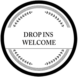 A circular sign with a black border, white background, and the black text 