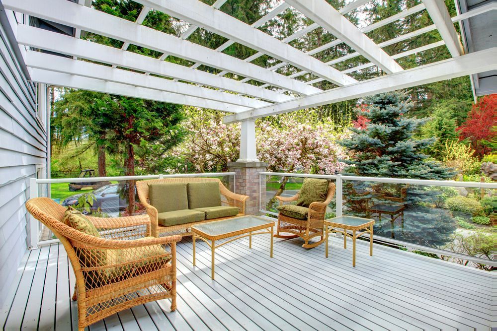 A Patio With a Couch, Chairs, and a Table Under a Pergola — Central Coast Property Maintenance Services In Kincumber, NSW