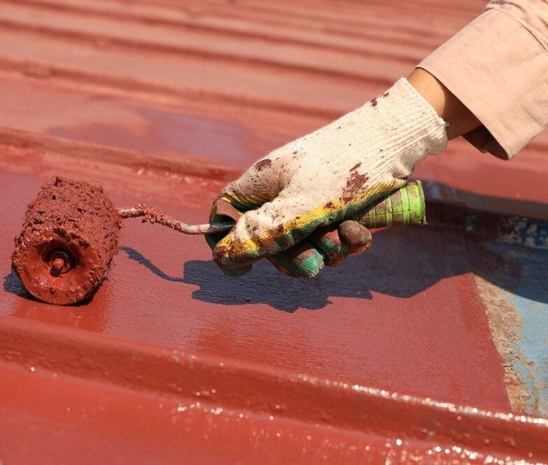 A Person is Painting a Roof With a Roller — Central Coast Property Maintenance Services In Killcare, NSW
