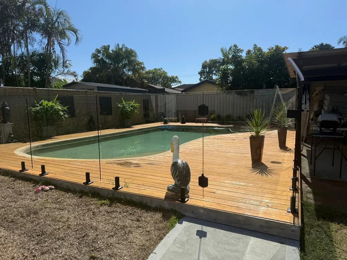 A Large Swimming Pool is in the Backyard of a House — Central Coast Property Maintenance Services In Umina Beach, NSW