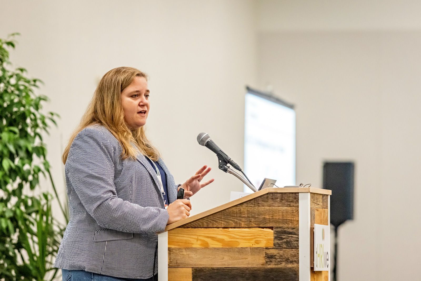 Cultivate speaker at a podium presenting