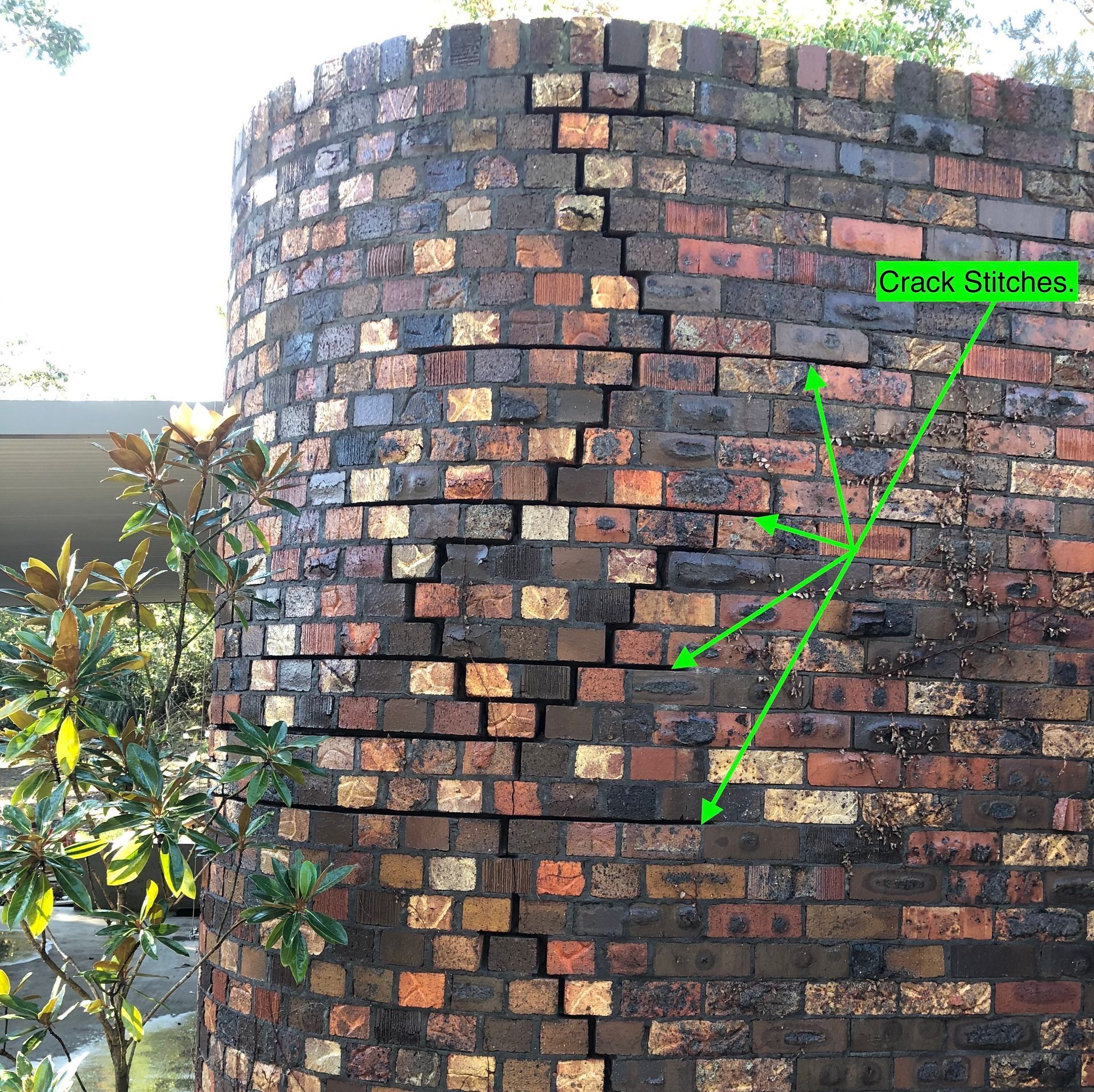A Man Is Laying Bricks On A Wall With A Trowel — Heritage Bricklaying & Remedial Services In Jilliby, NSW