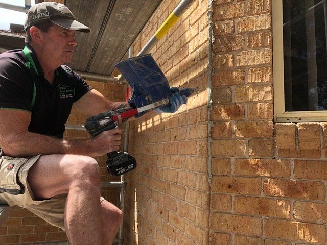 Man Repairing Brick Salt Damage — Salt Damaged Bricks In Central Coast, NSW