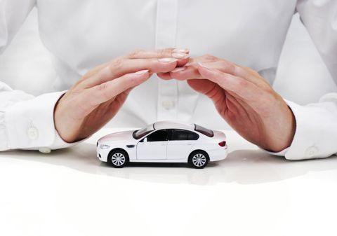 auto insurance man with hands over a car