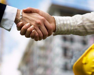 commercial insurance agreement construction guys shaking hands