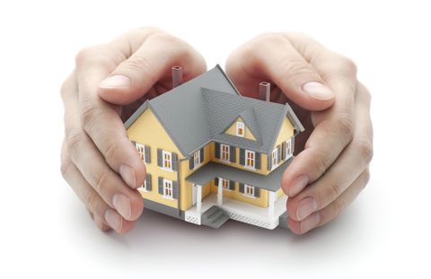 homeowners insurance coverage hands around a house