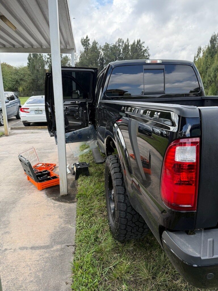 A man is working on the engine of a car.