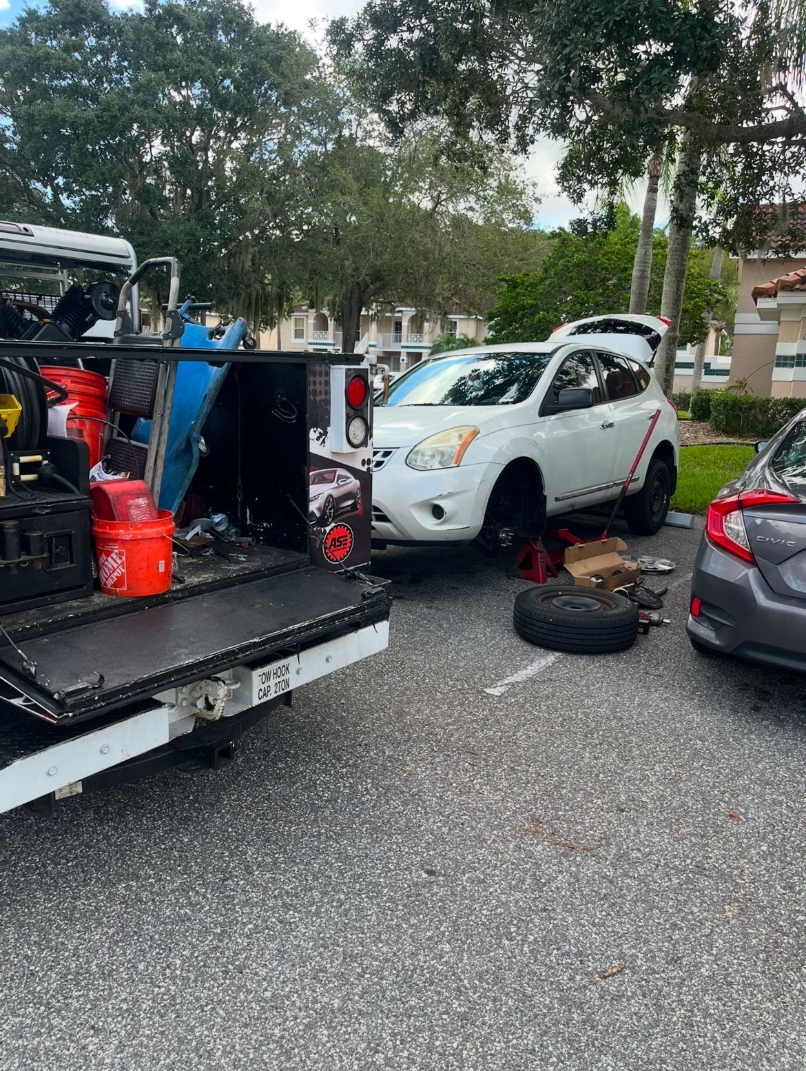 A truck is being towed by a fleet service oil & lube tow truck.