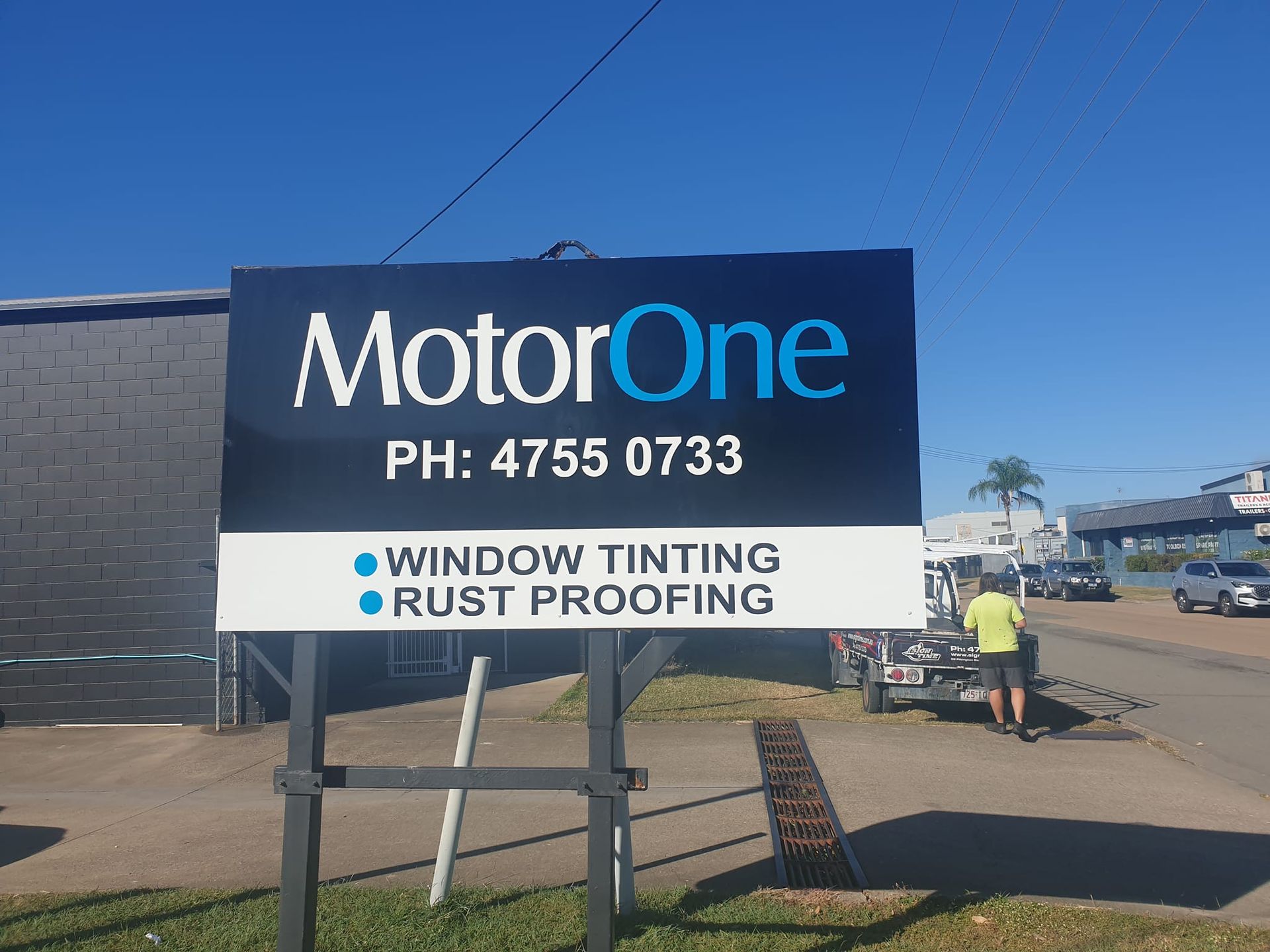 A sign for motorone window tinting and rust proofing