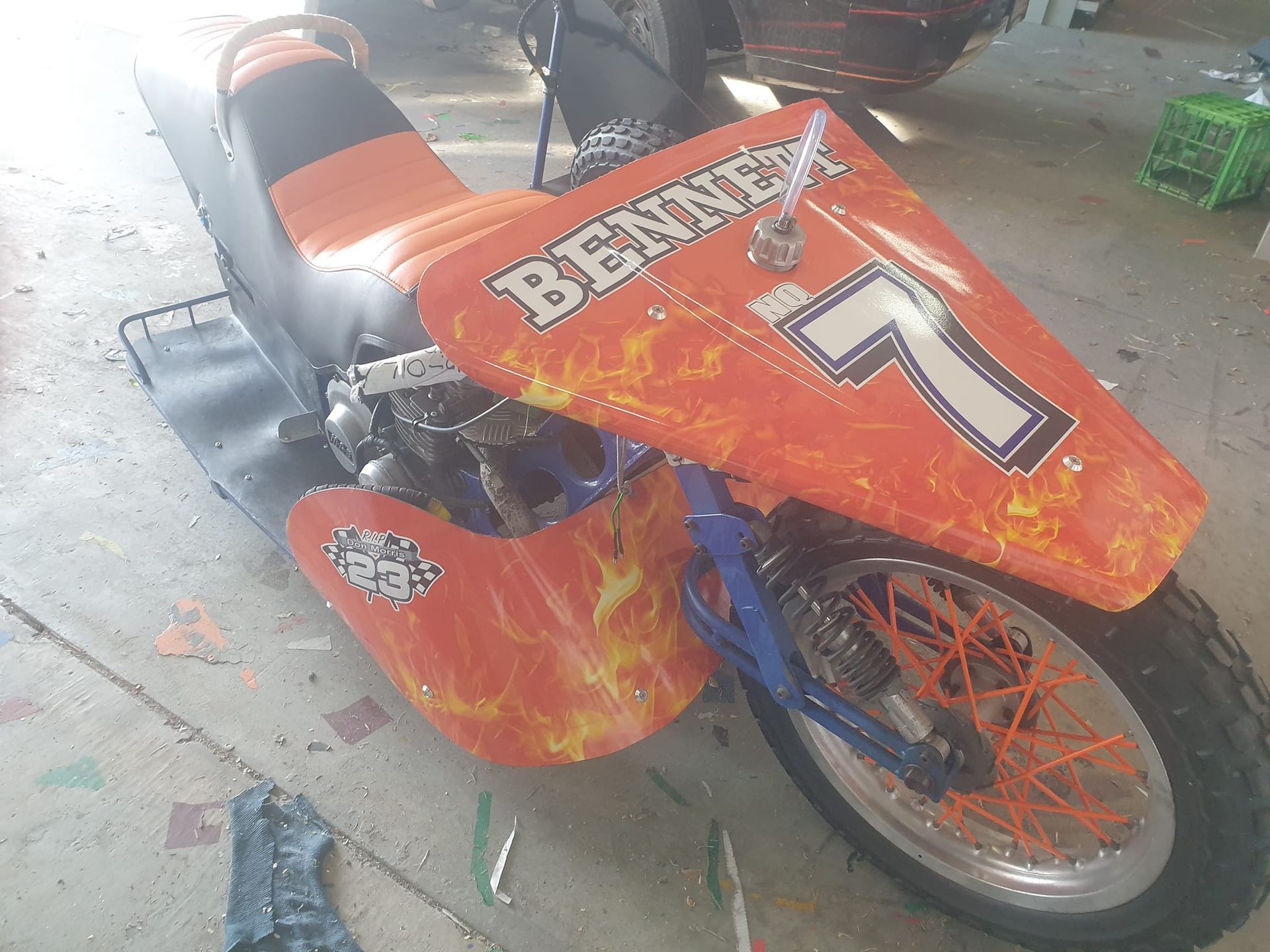 An orange motorcycle with the number 7 on it