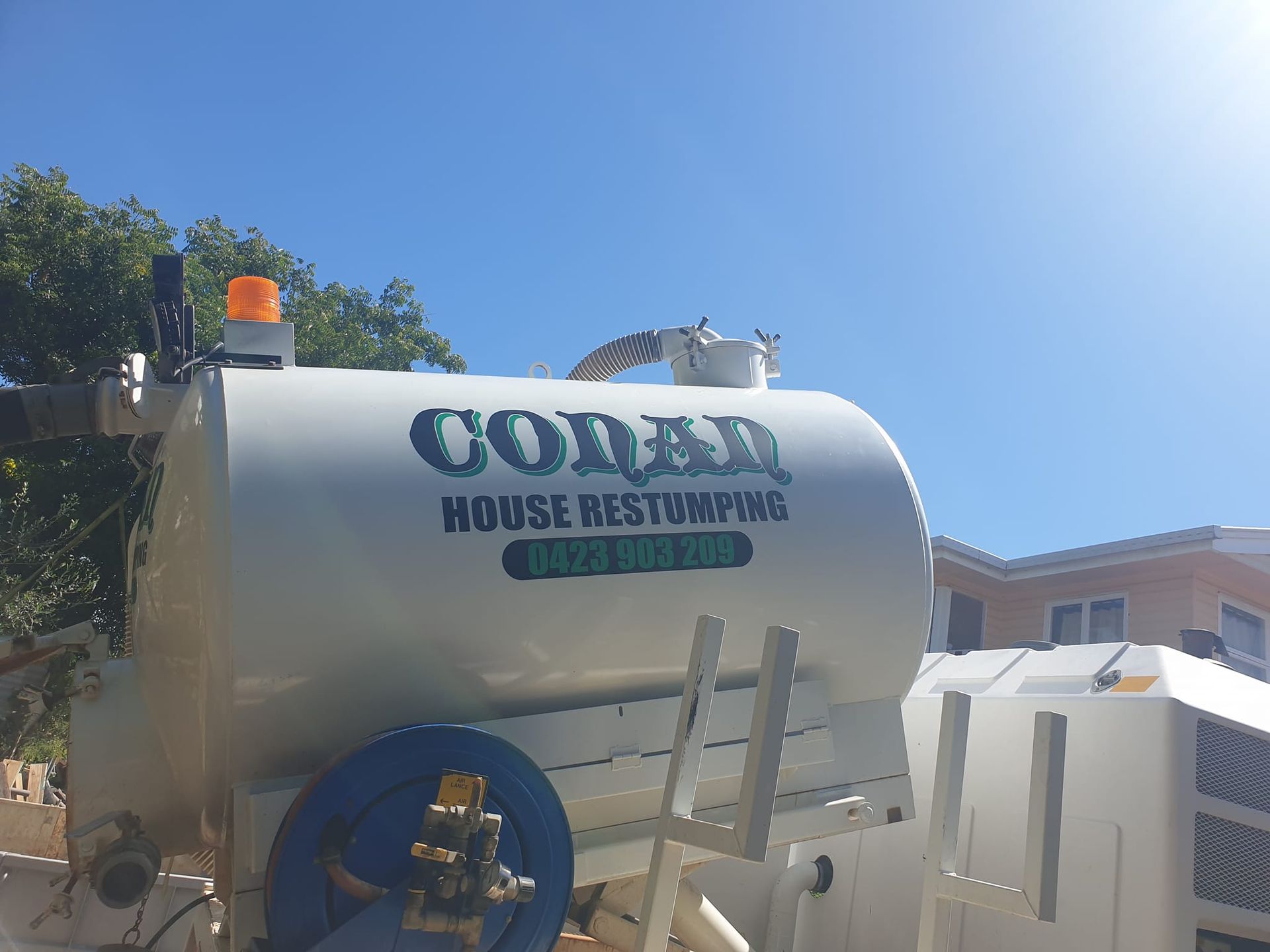 A white tank with the word coral on it