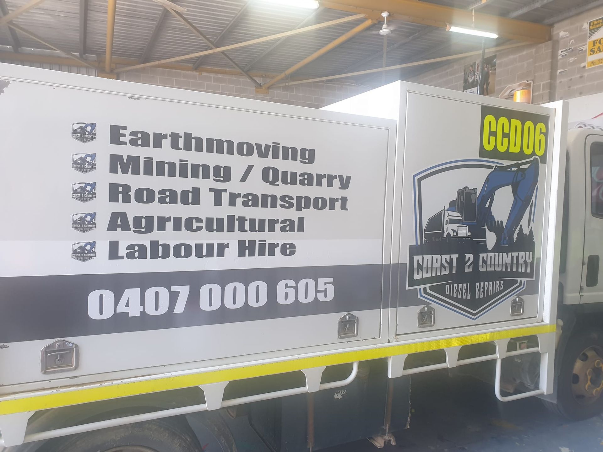 A white truck with a sign on the side that says ccd06