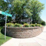 street signs and planter with business name sign