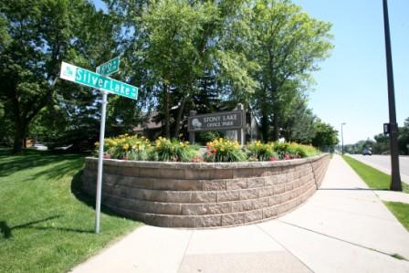 street signs and planter with business name sign