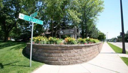 street signs and planter with business name sign