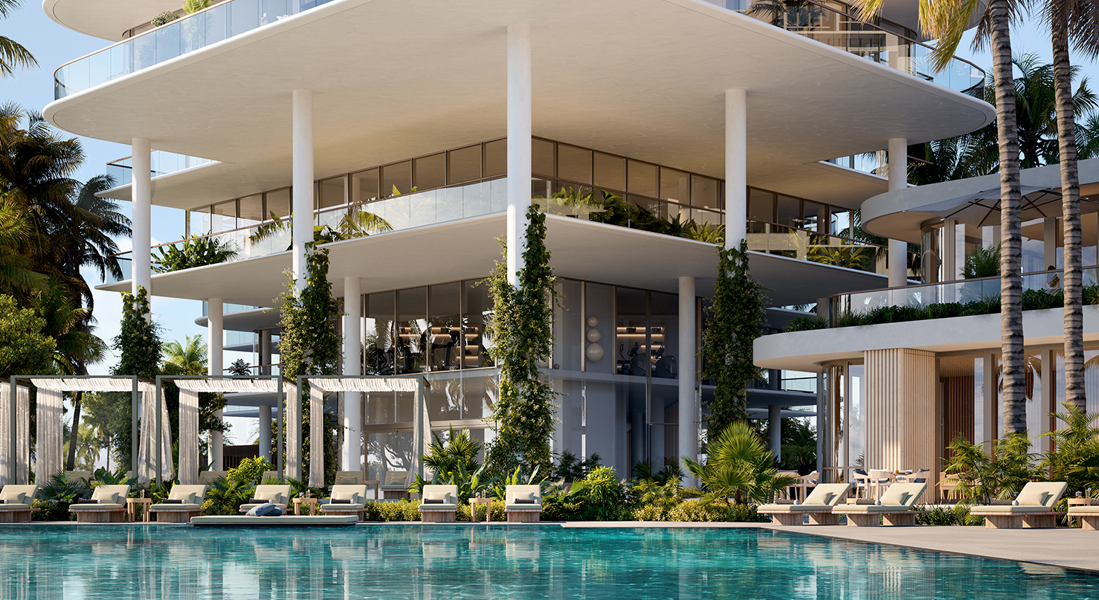 Modern white multi-level resort villa with lush greenery beside a turquoise pool