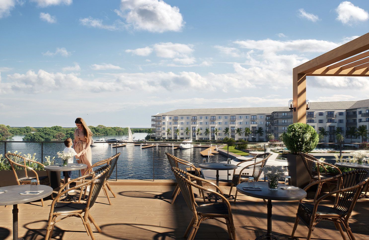 Rooftop restaurant patio overlooking the water, with tables, chairs, and a bright blue sky.