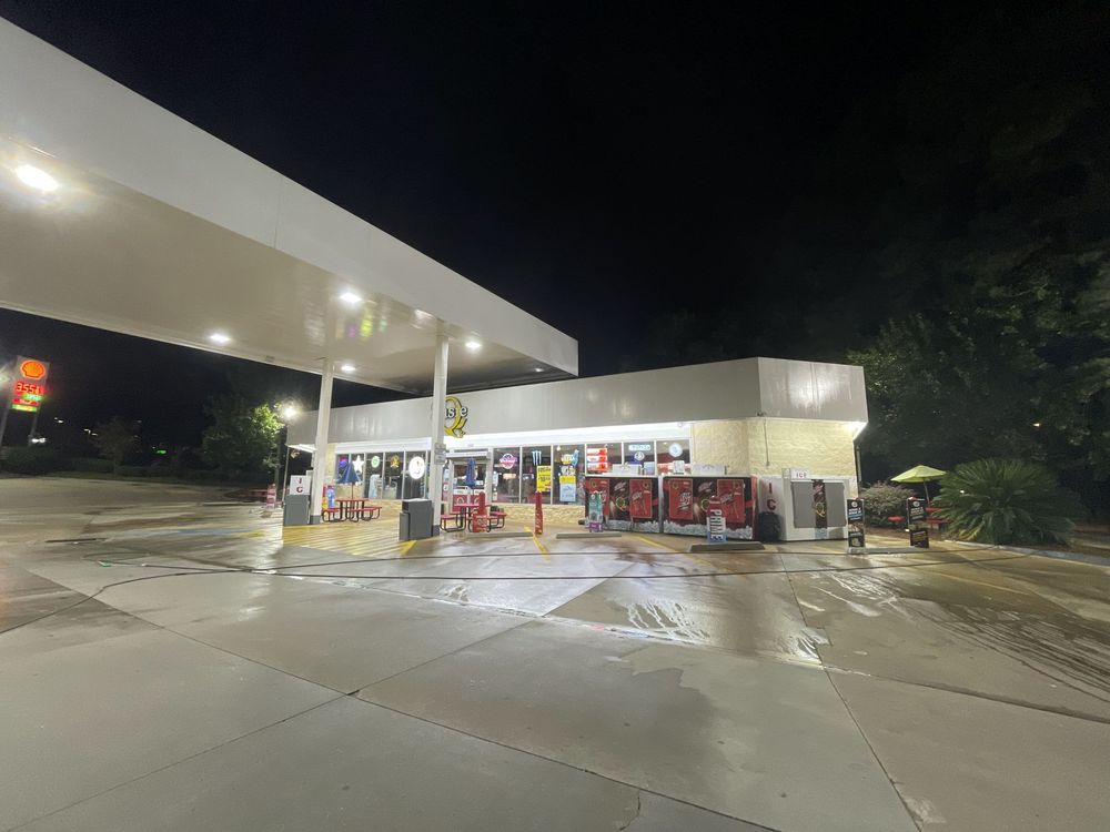 A gas station is lit up at night.