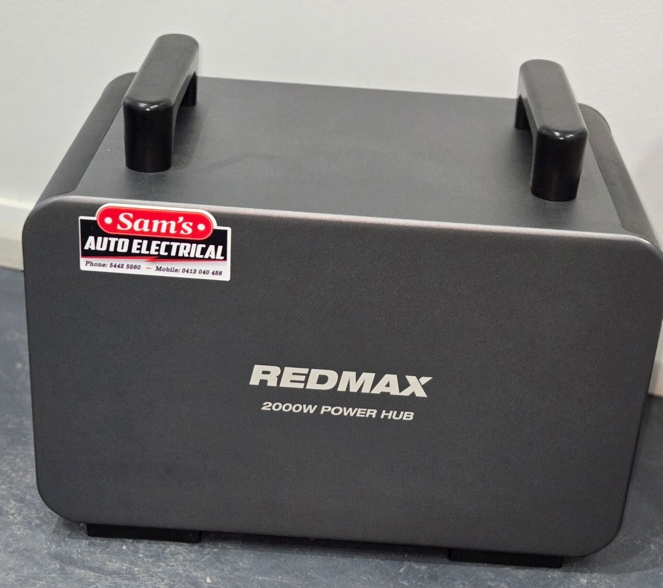 A Black Box is Sitting on Top of a Wooden Table in a Store — Sam’s Auto Electrical In Golden Square, VIC