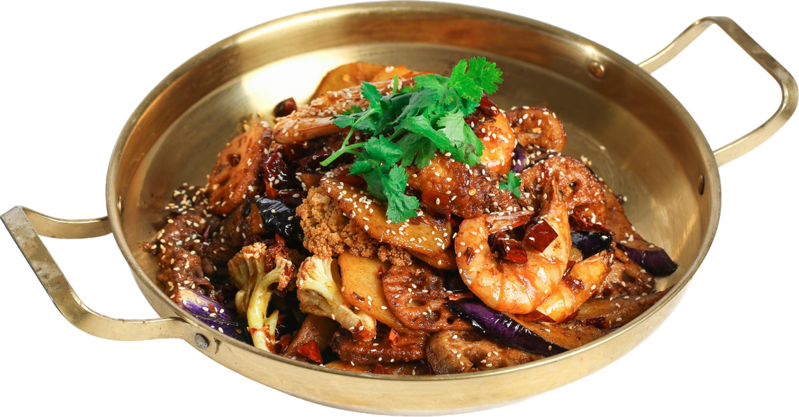 Braised meat and vegetables in a brass serving dish, garnished with fresh herbs