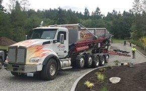 Rock Slinger Service — Truck Dumping Gravel in Puyallup, WA