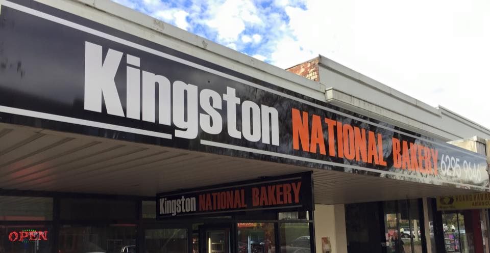 A Sign For Kingston National Bakery Is Hanging From The Roof Of A Building — Capital Signs in Goulburn, NSW