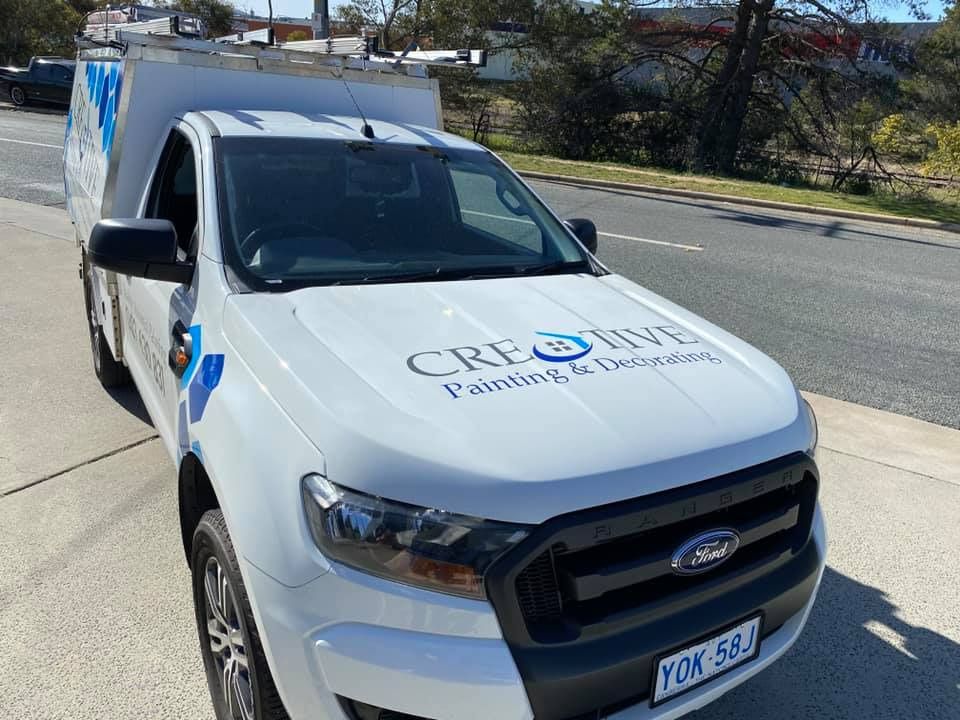 A White Ford Truck Is Parked On The Side Of The Road — Capital Signs in Cooma, NSW