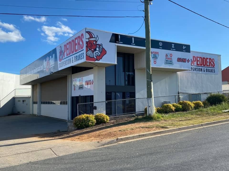 A Large White Building With A Red Viking On The Side Of It — Capital Signs in Cooma, NSW