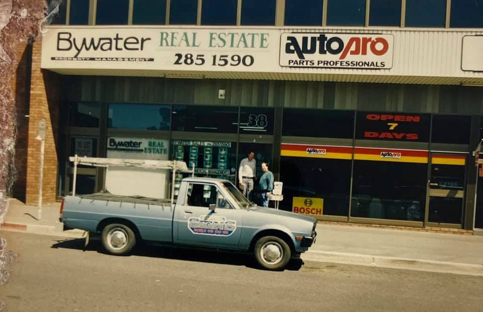 A Blue Truck Is Parked In Front Of A Building That Says Bywater Real Estate — Capital Signs in Fyshwick, ACT