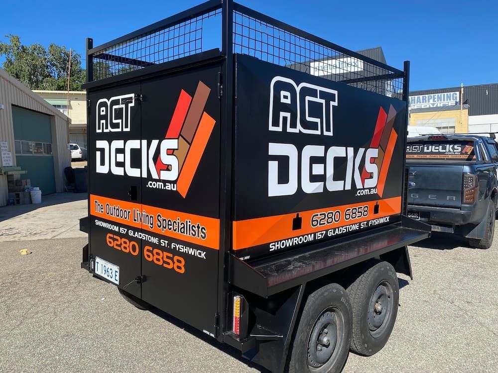 A Trailer For Act Decks Is Parked Next To A Truck — Capital Signs in Fyshwick, ACT