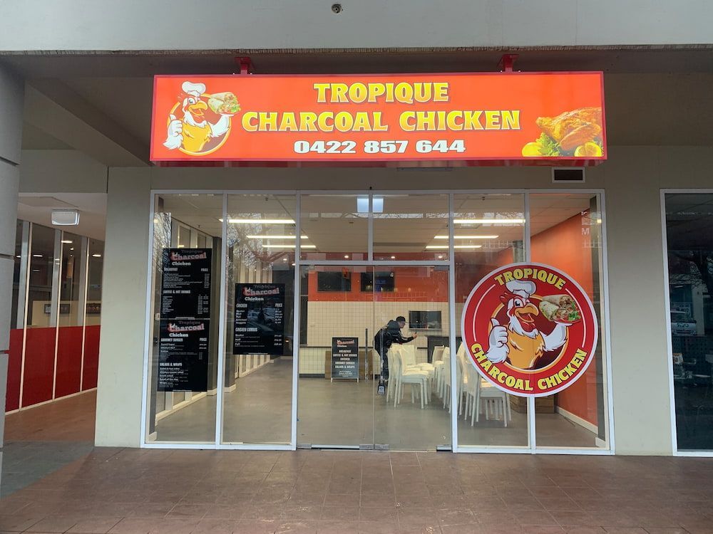 A Restaurant With A Sign That Says Tropical Charcoal Chicken — Capital Signs in Fyshwick, ACT