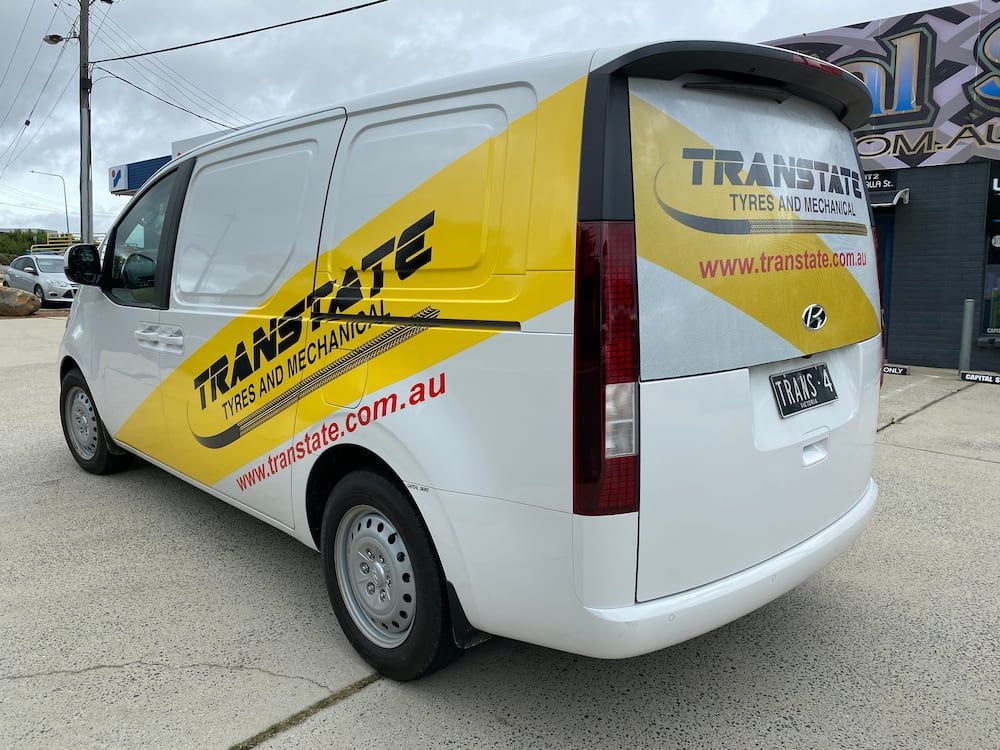 A White And Yellow Van With The Word Translate On It — Capital Signs in Canberra, ACT